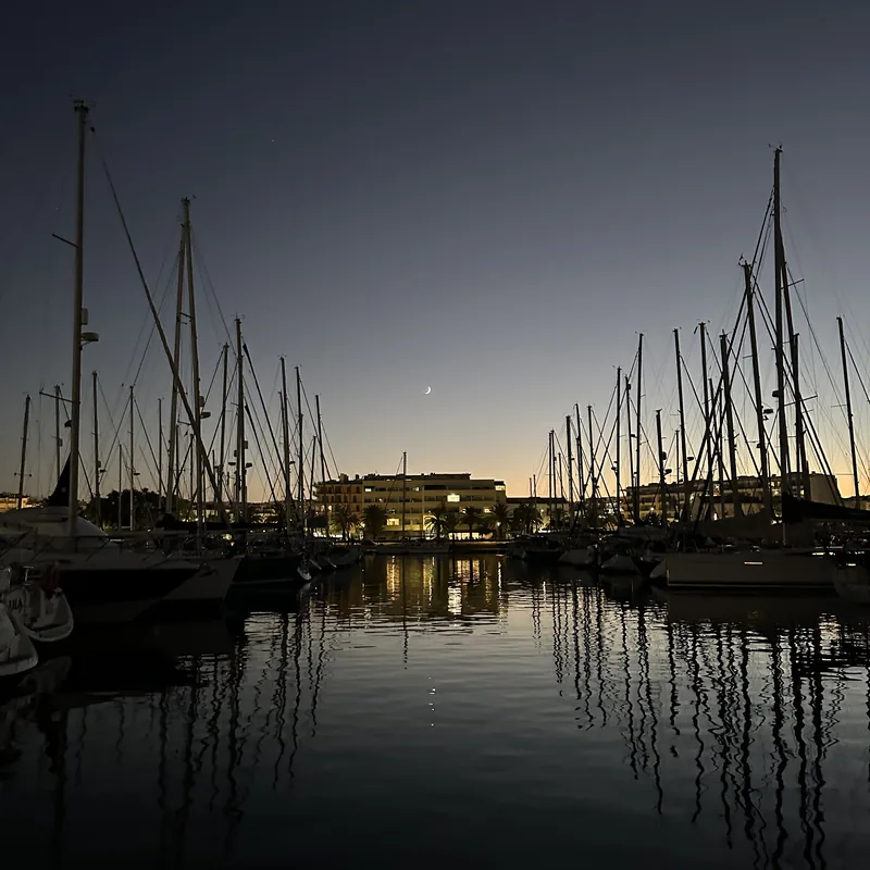 Marina de Lagos at dusk, with masts reflected in the water