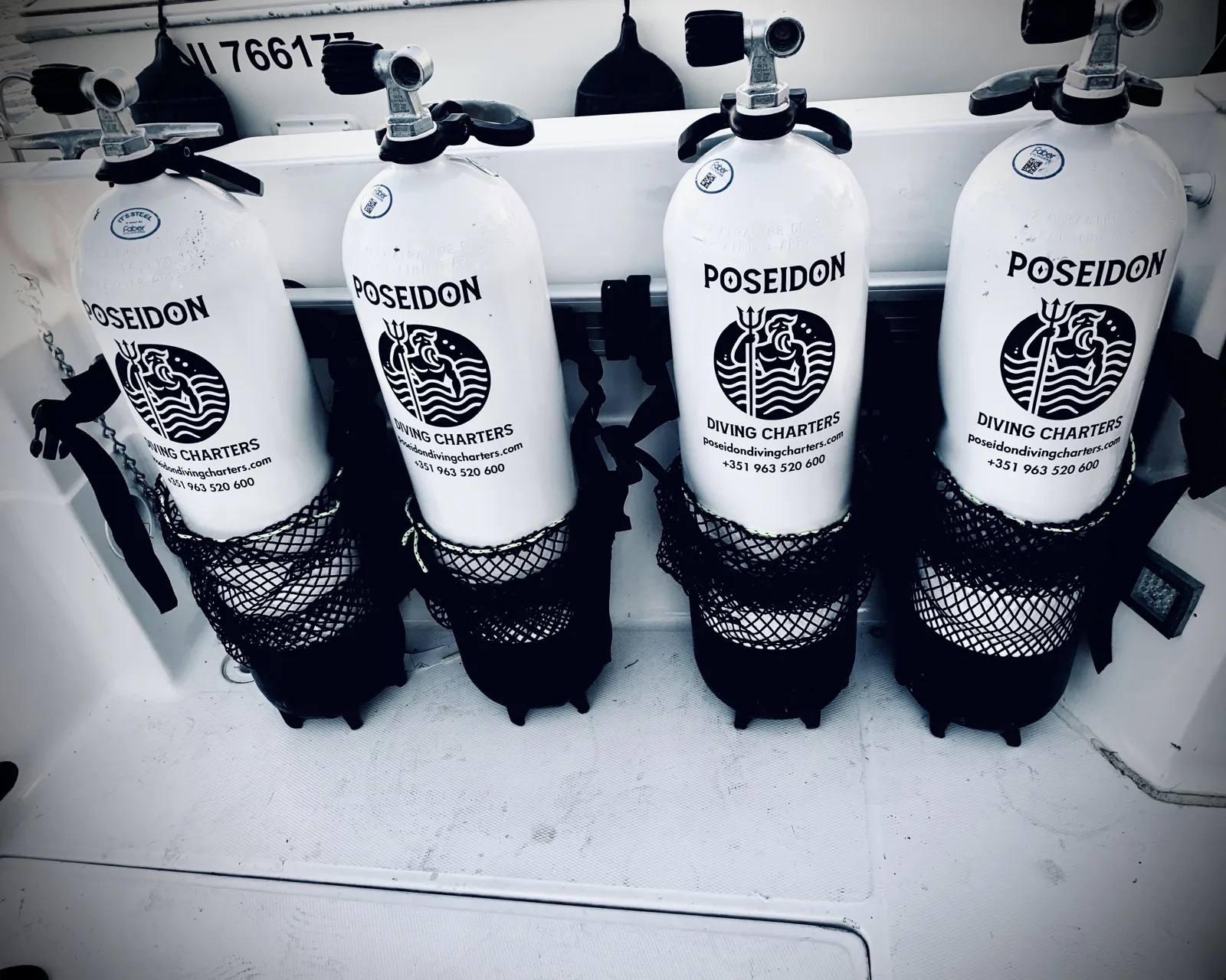 Poseidon scuba tanks racked on board, ready for the dive